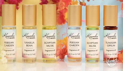 Kuumba Made Fragrances and products in a photo with flowers