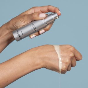 Jan Marini C-ESTA Face Serum bottle and swatch on model hand